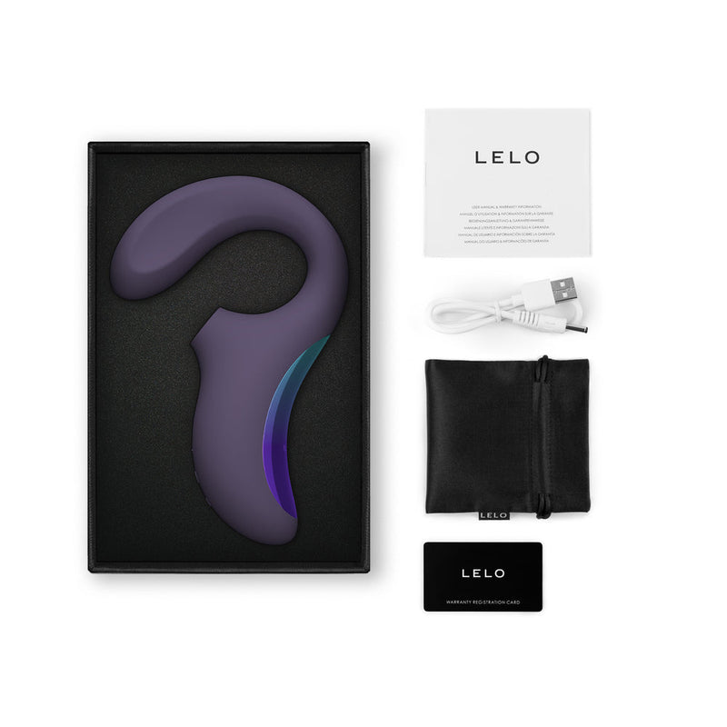 LELO Enigma Wave Suction Dual Stimulator Cyber Purple in box with accessories including manual and charging cable.