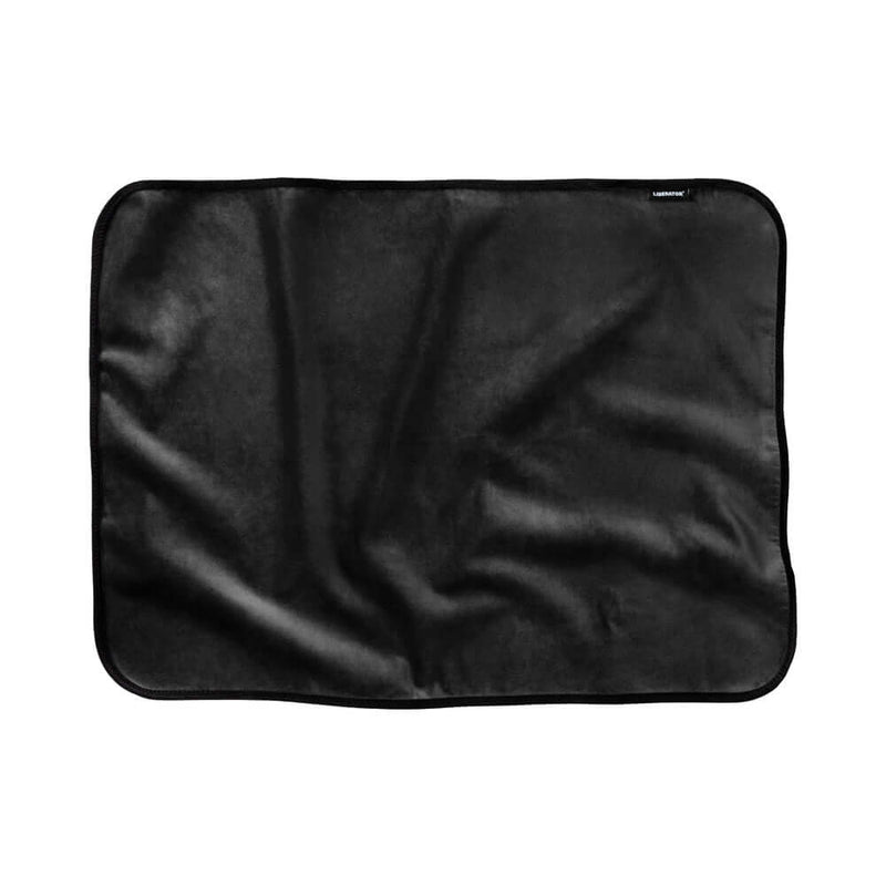 Liberator Fascinator Mini Waterproof Throw Blanket Black displayed on a surface, showcasing its plush and waterproof design.