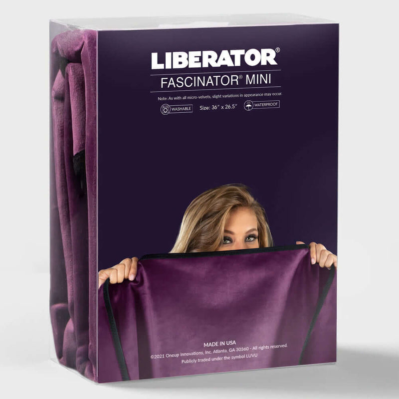 Liberator Fascinator Mini Waterproof Throw Blanket Black packaging with a woman holding it, showcasing its plush design.