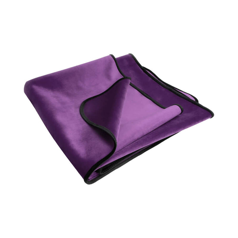 Liberator Fascinator Mini Waterproof Throw Blanket Purple folded elegantly, showcasing its plush texture and waterproof design.