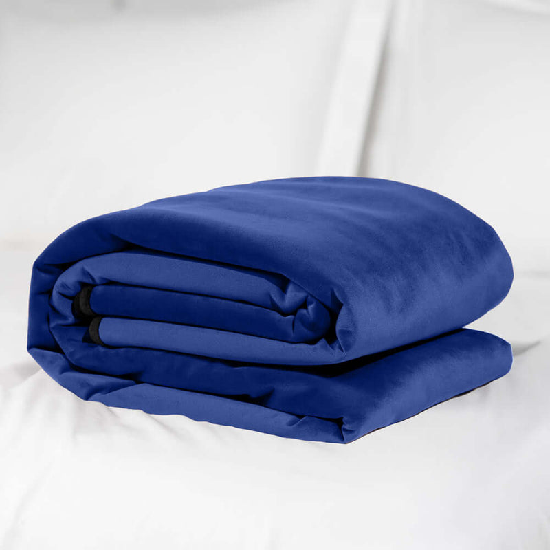 Liberator Fascinator Mini Waterproof Throw Blanket Blue folded on a bed.