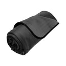 Liberator Fascinator Waterproof Throw Regular Blanket Black rolled up for versatile indoor and outdoor use.