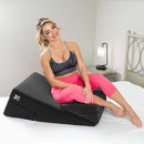 Liberator Wedge and Ramp Sex Positioning Pillow Combo Black used in a bedroom setting with a smiling woman.