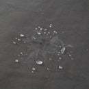 Close-up of water droplets on the Liberator Fascinator Waterproof Throw Travel Blanket Gray, showcasing its waterproof feature.