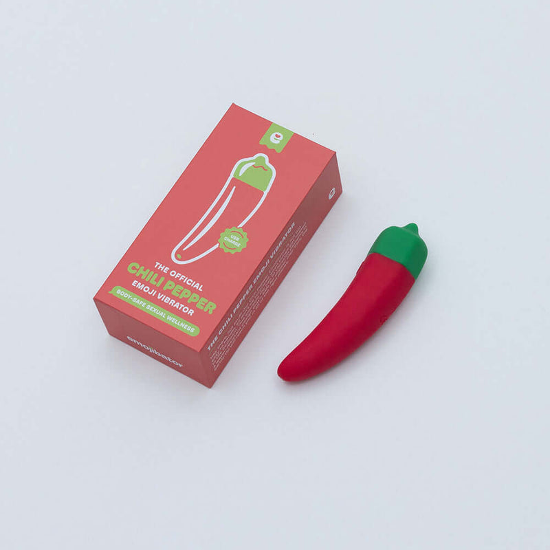Emojibator Chili Pepper USB Vibrator next to its packaging on a white background.