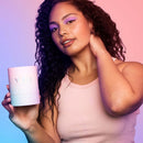A person holding the VUSH Gloss Pocket Rocket Bullet Vibrator in a stylish setting.