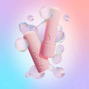 VUSH Gloss Pocket Rocket Bullet Vibrator in pink surrounded by bubbles on a colorful background.