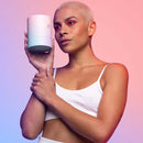 Model showcasing the VUSH Plump Palm Squishy Vibrator in a stylish pose with colorful lighting.