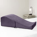 Liberator Flip Ramp Sex Positioning Pillow Plum resting on a bed, designed for enhancing intimate experiences.