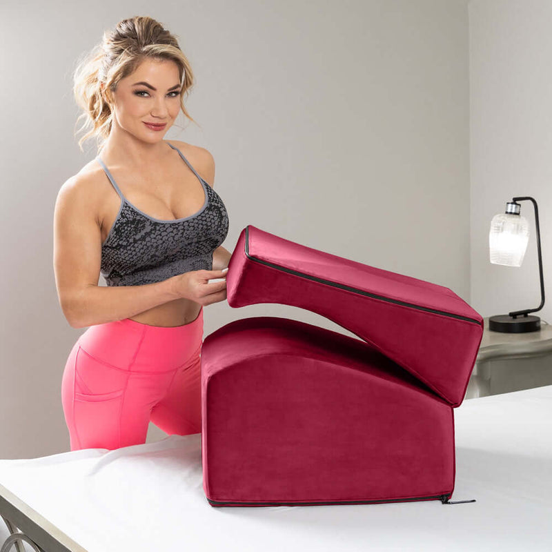 Liberator Flip Ramp Sex Positioning Pillow Merlot displayed with a woman showcasing its dual-purpose design.