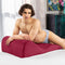 Liberator Hipster Sex Positioning Pillow Merlot featured with a man lying on it, showcasing its stylish design and comfort.