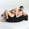 Couple enjoying intimacy on the Liberator Scoop Rocker Valkyrie Edition with Cuffs Black for enhanced pleasure.