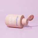 Playground Love Sesh Water-based Personal Lubricant bottle with a creamy texture on pink background.