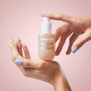 Playground Mood Maker Intimacy Oil in hands, showcasing its silky texture and appealing packaging.