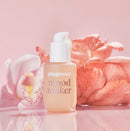 Playground Mood Maker Intimacy Oil bottle surrounded by orchid and coral mushroom, creating a serene mood.