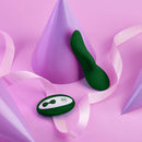 FemmeFunn Unda Panty Vibe Dark Green vibrator and remote on pink background with party cones.