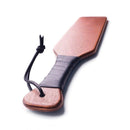 Stockroom Essentials Leather Wrapped Spanking Paddle featuring a smooth wooden face and leather-wrapped handle.