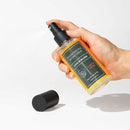 Eye of Love Bloom Attract Her Pheromone Room Spray Earths Desire 5 Oz held in hand with cap beside it.