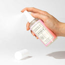 Eye of Love Bloom Attract Him Pheromone Room Spray Sunny Daze 5 Oz held in hand with spray nozzle.