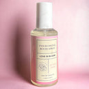 Eye of Love Bloom Attract Him Pheromone Room Spray Sunny Daze 5 Oz in a stylish bottle against a pink background.