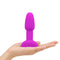 b-Vibe Rimming Petite Rotating Remote Control Plug Fuchsia in a hand, showcasing its vibrant purple design.