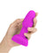 b-Vibe Rimming Petite Rotating Remote Control Plug Fuchsia held in hand, showcasing its vibrant color and design.