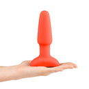 b-Vibe Rimming 2 Rotating and Vibrating Remote Control Plug Orange held in a hand, showcasing its unique design.