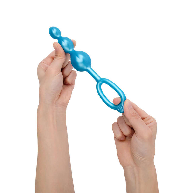 b-Vibe Beaded Butties Bundle 3-Piece Anal Plug Set held in hands, showcasing body-safe silicone design.