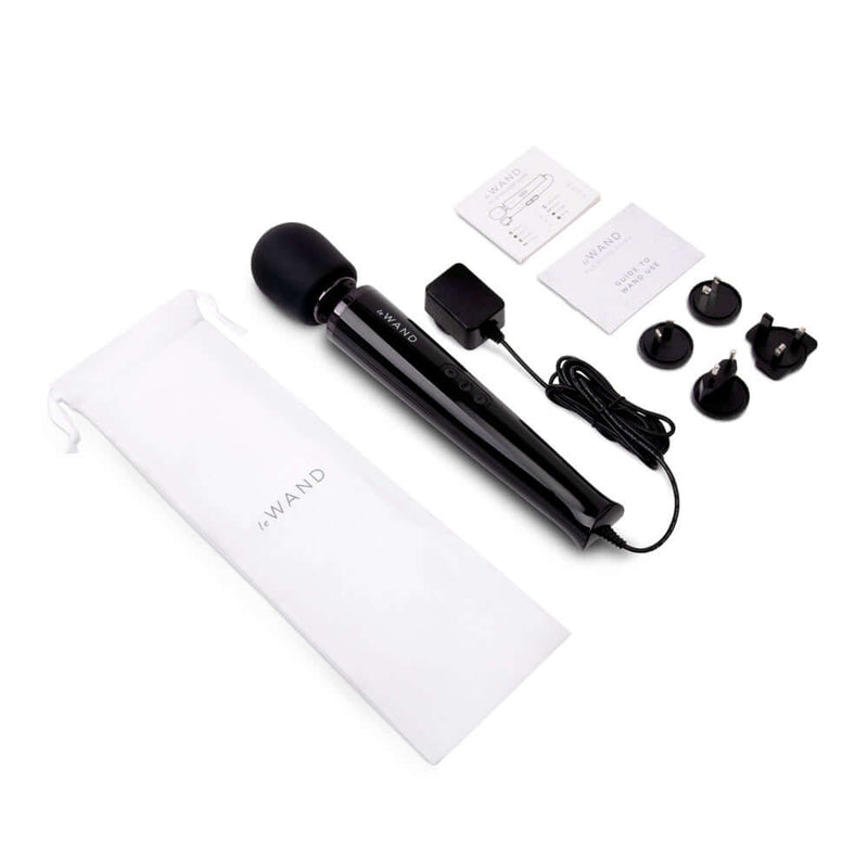 Le Wand Plug-In Vibrating Massager Black with accessories and white storage pouch.