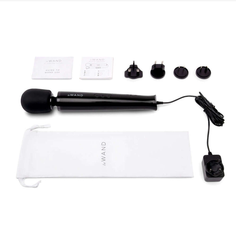 Le Wand Plug-In Vibrating Massager Black with accessories, user manual, and power adapter, perfect for endless pleasure.