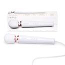 Le Wand Plug-In Vibrating Massager White displayed with its packaging, highlighting its elegant design and functionality.