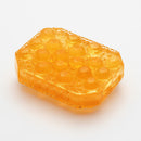 Tenga Uni Topaz Unisex Pleasure Sleeve in an amber color showcasing a unique round-cut texture.