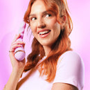 Woman holding the VUSH Siren Twist Vibrator, showcasing its innovative design and vibrant color.