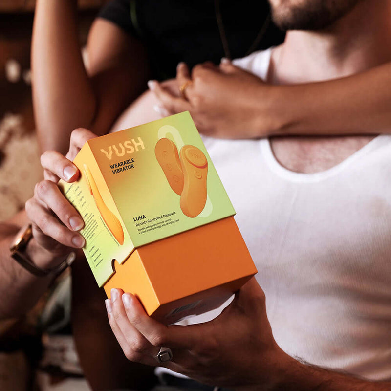 VUSH Luna Wearable Vibrator packaging held by person, showcasing the product design and branding.
