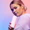 Model holding VUSH Glow Rabbit Vibrator against a colorful pastel background.