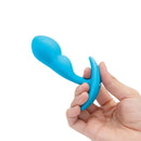 b-Vibe Vibrating P-Spot Snug Plug Small with Remote Control held in hand, showcasing its sleek design and ergonomic shape.