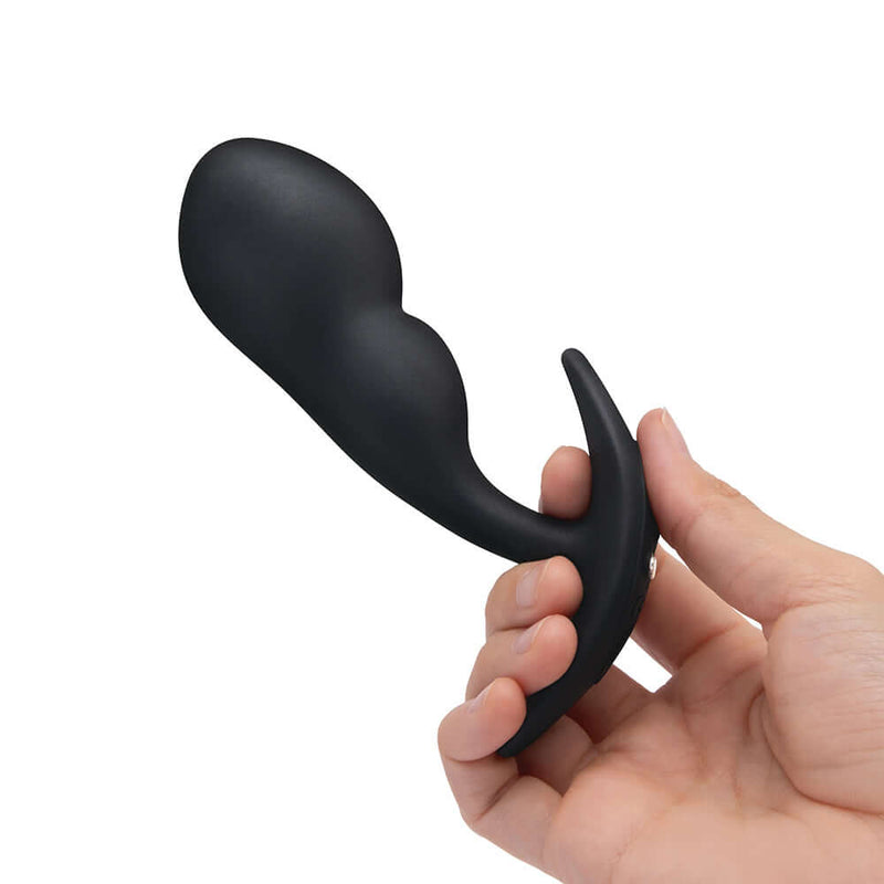 b-Vibe Vibrating P-Spot Snug Plug Large with Remote Control held in hand for prostate stimulation