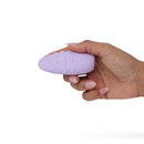 Je Joue Mimi Deux Double Sided Clitoral Vibrator Lilac held in hand showing soft pleasure dots.