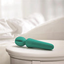 Adam & Eve Eve's Petite Private Pleasure Wand resting on a table, showcasing its compact palm-sized design.