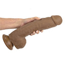 Adam & Eve Adam's Colossal 12 Inch Dildo Brown held in hand, showcasing its realistic design and prominent details.