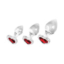 Adam & Eve Red Heart Gem Glass Plug Set featuring three graduated glass plugs with red heart-shaped gem bases.