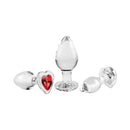 Adam & Eve Red Heart Gem Glass Plug Set featuring three graduated glass plugs with red heart-shaped gem bases.