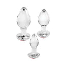 Adam & Eve Red Heart Gem Glass Plug Set featuring three graduated glass plugs with heart-shaped gem bases.