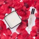 Eye of Love Love in Transit Confidence Attract Her Pheromone Gift Set with candle and fragrance on rose petals.