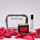 Eye of Love Romantic Attract Her Pheromone Gift Set displayed with a clear pouch, candle, and fragrance next to rose petals.