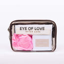 Eye of Love Love in Transit After Dark Attract Him Pheromone Gift Set in a stylish package with pink petals.