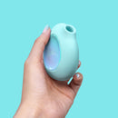 Biird Lumii Clitoral Suction Stimulator Mint held in hand against a mint green background.