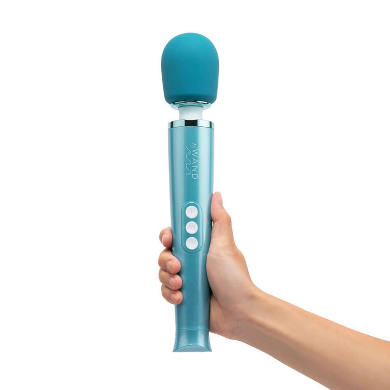 Le Wand Dive Submersible Rechargeable Vibrating Massager held in hand with blue silicone head and control buttons.