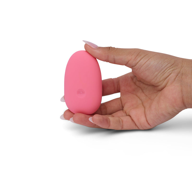 ILY by Je Joue The Pebble Squishy Pebble Shaped Bullet held in hand, highlighting its small size and soft texture.