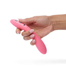 Close-up of a hand holding the Je Joue ILY The Wand Flexible Warming G-Spot Wand in pink silicone.